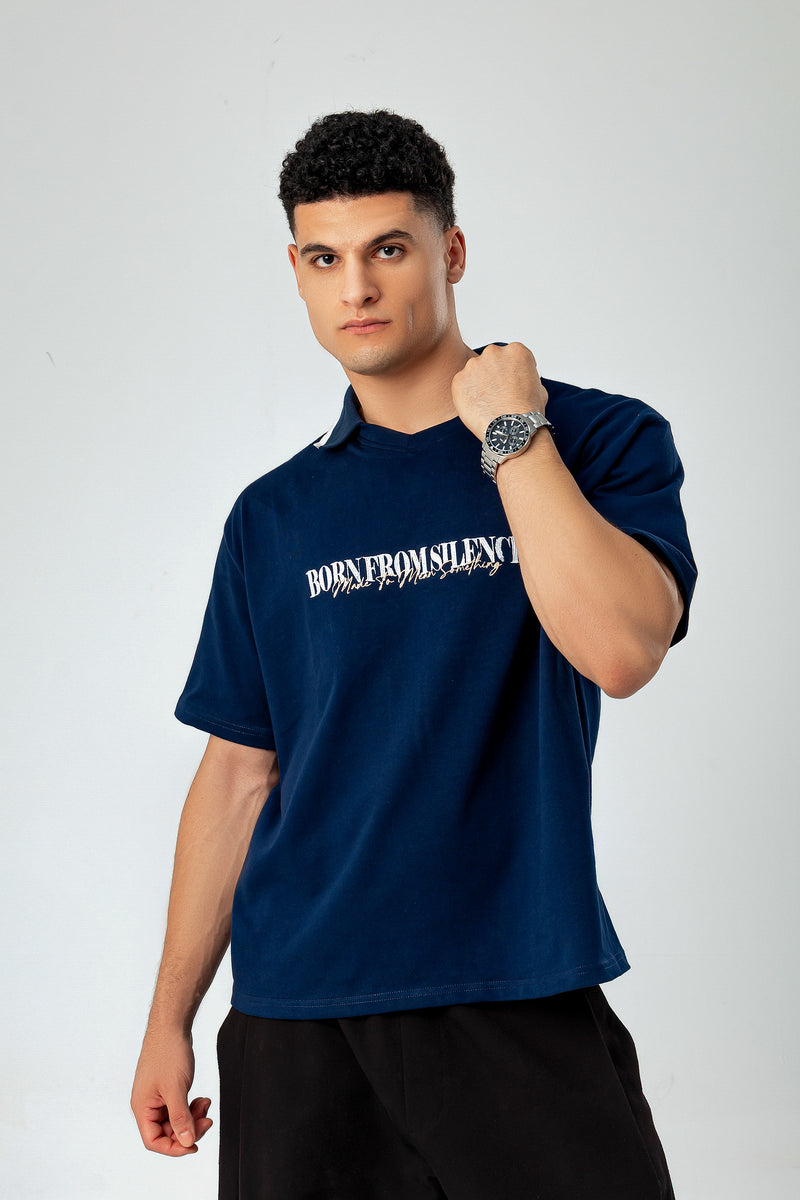 Model in LUNEX navy boxy polo tee — oversized drop-shoulder fit