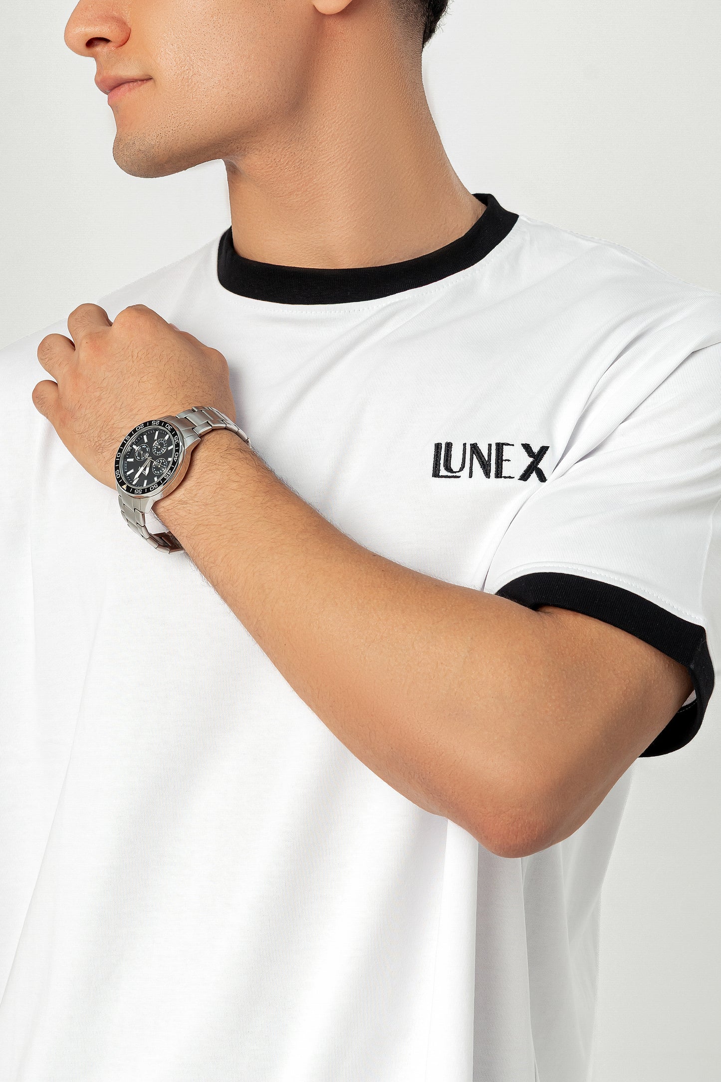 Close-up of embroidered "LUNEX" logo and black ringer trim