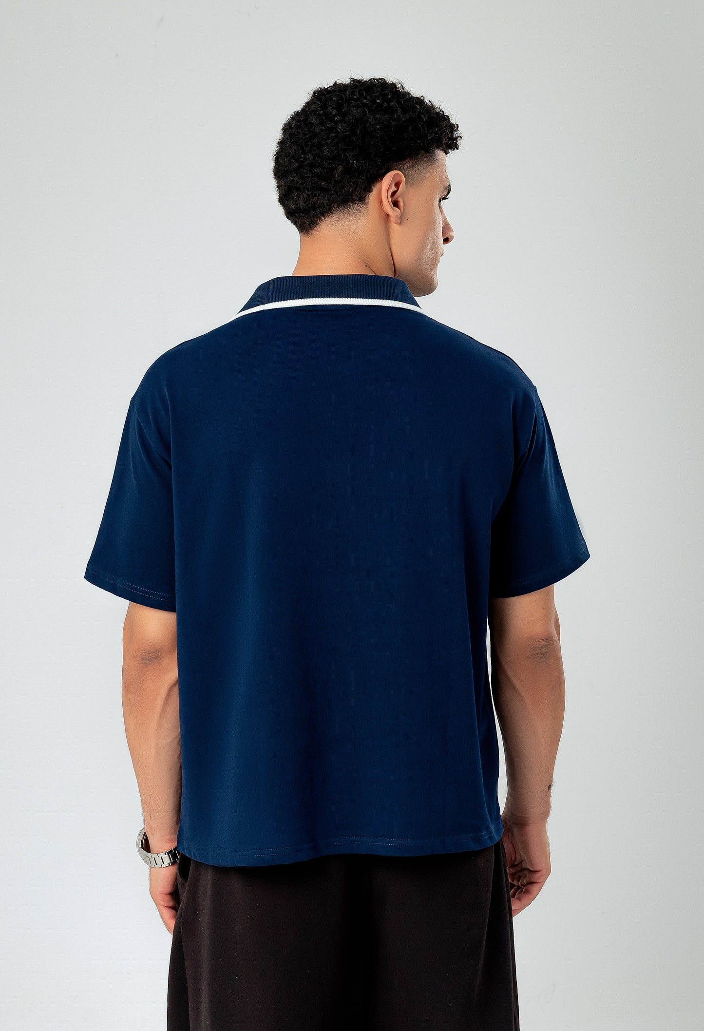 Back view of LUNEX navy oversized boxy polo tee