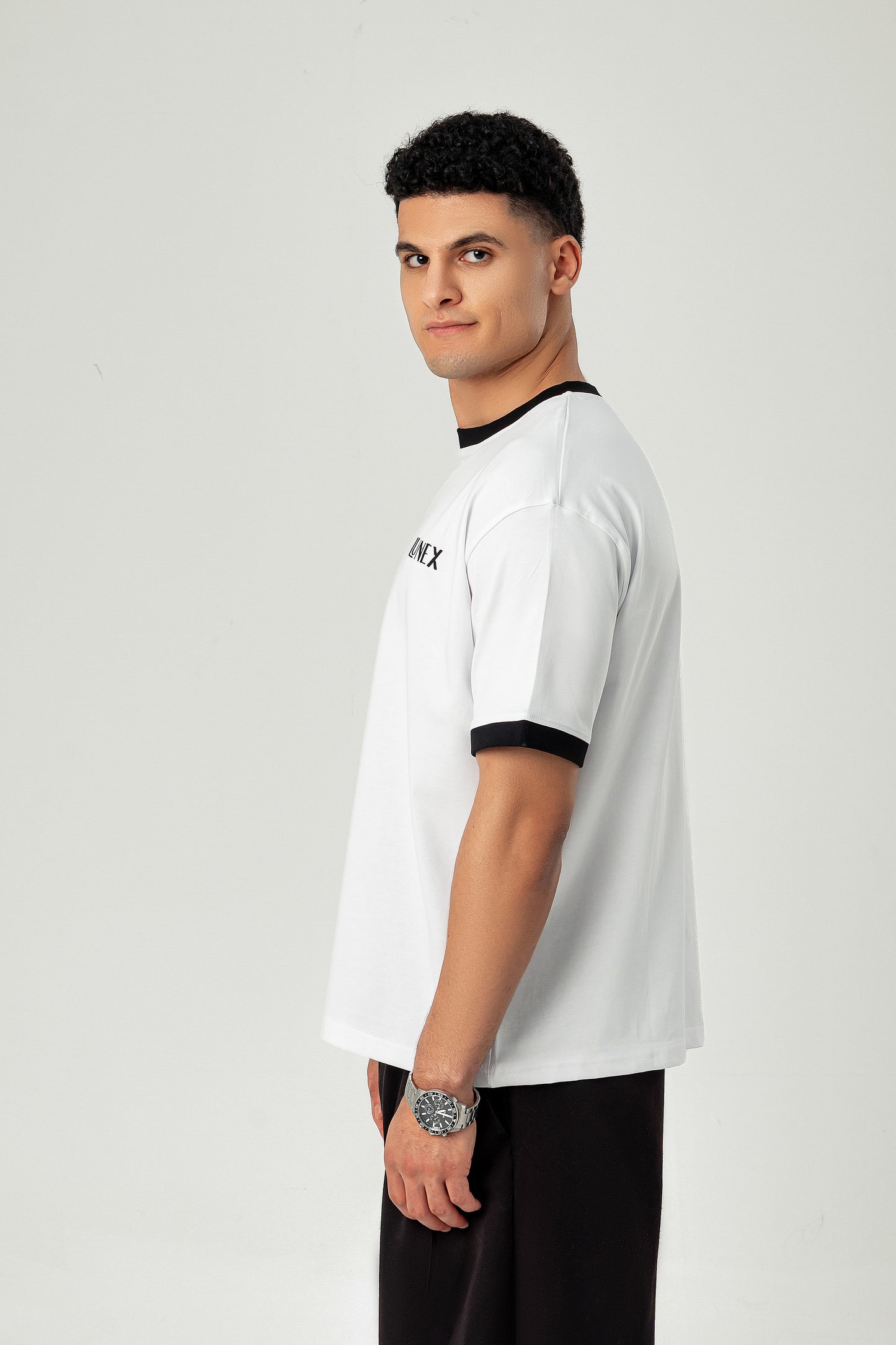 Side view of LUNEX white ringer tee with black trim